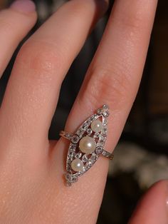 A very special Platinum and Diamond example, this gorgeous, late 19th century, Belle Epoque ring is couture for the hand. Lacy spindles radiate from three (likely natural) pearls, among rose cut diamonds kissed by platinum twinkle around them, all elegantly tucking into a Navette shape. This wonderful, transitional period jewel is of no small size, either, consuming 1.40" of length, and with .75ctw estimated of diamonds. One peek at the gallery, or the sunburst reverses of the pearls will always delight the astute ring curator; this is a remarkable example, with the proper French hallmarks, to boot. age/ origin: French, 1890-1910 Materials: 18ct, platinum, diamonds .75ctw Measurements; Ring size 7.75 Condition: Excellent, quite near mint condition. We just acquired this beauty in France, a Hourglass Pendant, Chevron Earrings, Chevron Bracelet, Chevron Necklace, Chevron Ring, Cameo Pendant, Jewel Box, Vintage Pearls, Fantasy Jewelry