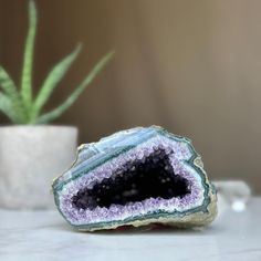 This deep purple amethyst geode cave has the highest quality of the semi precious stones. This geode has beautiful large crystals and agate bands. Combine design and wellness by adding an amethyst geode to the decoration of your spaces. Its vibrant deep purple color is characteristic of the geodes extracted from URUGUAY, one of the few places in the world where you can find. YOU WILL RECEIVE THE PIECE OF THE PICTURE!! ✧ MEASURES: Height: 2.5 in. x Width: 4 in. Weight 1.6 lb (765 gr). ✧     Our gemstones was packaged one by one very carefully in a PREMIUM RIGID GIFT BOX with cushioned interior protection that protects it from any impact, (do not risk buying stones wrapped in just a paper). The premium gift box allows you to give it as a jewelry piece. ✧     The back and base of these amethy Spiritual Healing Gemstone Geodes, Amethyst Geodes For Healing, Large Agate Geode For Spiritual Purposes, Large Agate Geode For Spiritual Use, Healing Agate Geode Gemstones, Large Spiritual Geodes For Healing, Healing Gemstone Geodes, Unique Healing Gemstone Geodes, Unique Healing Geodes