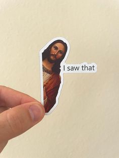 someone holding up a sticker with the image of jesus on it that says i saw that