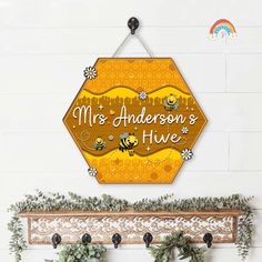 a wooden sign that says mrs anderson's hive with bees and flowers on it