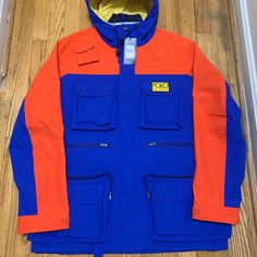 Ralph Lauren Polo High Tech Royal Blue And Orange Jacket Size Large New With Tags And Even The Zipper Is Wrapped And Great Details And Quality Multicolor Outerwear With Pockets For Work, Multicolor Workwear Outerwear With Pockets, Blue Outerwear With Patch Pockets For Outdoor, Functional Orange Long Sleeve Outerwear, Blue Outerwear With Patch Pockets For Streetwear, Functional Orange Outerwear For Fall, Casual Orange Color Block Outerwear, Blue Utility Jacket For Outdoor Fall, Blue Utility Jacket For Fall Outdoor Activities