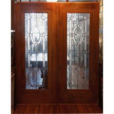 two stained glass doors with wood flooring in front of the door and sidelights