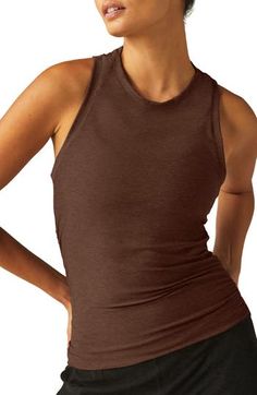 Move from the yoga studio to running errands in ultimate comfort in this superstretchy tank boasting a sporty racerback and subtly ruched seams. 21" length (size Medium) Crewneck Racerback 94% polyester, 6% elastane Machine wash, tumble dry Made in the USA of imported fabric Brown Fitted Sleeveless Activewear, Versatile Brown Yoga Activewear, Brown Athleisure Activewear For Yoga, Brown Sleeveless Activewear For Sports, Sporty Brown Stretch Top, Brown Sleeveless Activewear For Workout, Brown Sleeveless Athleisure Activewear, Sporty Stretch Brown Tops, Stretch Brown Sports Tops