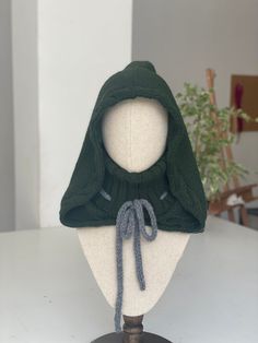 Magical hood knitted by hand with vegan acrylic yarn. One size! The main color and the secondary color (the color of the cord) is customizable. Oat color: https://etsy.me/3RC2tQ9 Black color: https://etsy.me/3RHYLoj Write me if you need a different color!