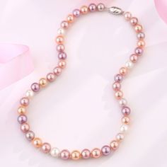 Choose this lavish AAA or AAAA multicolored freshwater pearl strand necklace for a dose of show-stopping color and mesmerizing uniqueness of these wondrous pearls. Colored pearls display harmonious body colors that uplift your wardrobe to another level of elegance. This classic single-strand necklace features completely natural lavender and pink fine quality AAA or AAAA pearls shimmering with pastel overtones and a bright luster. Unique and captivating, these high-quality lavender freshwater pea Round Pearl Necklace With Polished Beads, Elegant Multicolor Pearl Necklace For Formal Occasions, Elegant Round Necklace With Colorful Beads, High Luster Round Akoya Pearl Necklace, Multicolor Beaded Necklace With Pearl Pendant, Silver Pearl Necklace With Colorful Beads, Elegant Multicolor Pearl Chain Necklace, Elegant Multicolor Single Strand Necklace, Formal Multicolor Polished Bead Necklaces