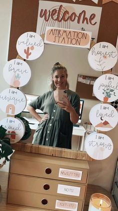 a woman taking a selfie in front of a mirror with many signs on it