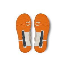 an orange and white pair of shoes on a white background