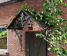 an old brick building with green vines growing over the door and window sill on it