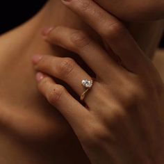 a woman's hand with a diamond ring on her finger