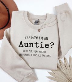 Welcome to our cozy corner of Etsy, where style meets sass with a touch of sweetness! Our Demure but Funny Auntie Sweatshirt is the perfect blend of elegance and humor--just like your favorite auntie. Crafted for those who cherish subtle sophistication with a wink of wit, this sweatshirt is a must-have for any aunt who knows how to keep it classy while sharing a laugh. .: Made with a medium-heavy fabric blend of 50% cotton and 50% polyester (8.0 oz/yd² (271.25 g/m this sweatshirt feels cozy and is the perfect choice for those colder months. .: The classic fit along with the crew neckline deliver a comfy wearing experience with a clean-cut style. Meanwhile, the double-needle stitching at the shoulder, armhole, neck, waistband, and cuff seams add top-tier durability.  .: Say goodbye to itchi Auntie Sweatshirt Ideas, Aunt Outfits, Aunt Aesthetic, Auntie Sweatshirt, Gifts For Aunts, Auntie Life, Christmas Gifts For Aunts, Aunt Life, Gift For Aunt