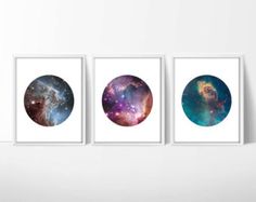 three framed photographs of the outer planets in different colors and sizes, hanging on a wall