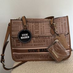 Steve Madden Bpierce Logo Handbag With Interior Crossbody Pouch And Keychain Id Wallet (New) Brand: Steve Madden Color: Tan Condition: New With Tags; Never Used Measurements: Length Across: 15 Inches Height: 10 3/4 Inches Width: 5 1/2 Inches Strap Drop: 11 1/2 Inches Detachable Belted Strap Is Adjustable Cross Body Strap Is Belted, Removable And Adjustable From 44 Inches To 48 1/2 Inches All Over Steve Madden Logo Handbag. Interior Logo Pouch That Can Be Used As A Crossbody Bag With The Removal Steve Madden Burgent Bag, Steve Madden Cross Body Bag, Interior Logo, Id Wallet, Steve Madden Bags, Bags Logo, Womens Tote Bags, Steve Madden, Cross Body