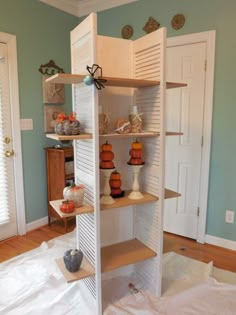 a room that has some shelves on the wall and pumpkins sitting on top of them