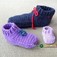 crocheted baby shoes and booties are on the floor next to a pencil