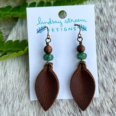 Boho western chic earrings are crafted with genuine leather in black or brown. Petals dangle from a duo of natural stone and wood beads. Lightweight style is the perfect everyday earring. Compliments any style from jeans and a flannel to a flowing floral sundress. - Genuine leather and natural stones - Earrings dangle 2.25" long on gold plated steel ear wires. Brown Dangle Earrings Nature-inspired, Nature-inspired Brown Dangle Earrings, Artisan Brown Earrings With Wooden Beads, Adjustable Brown Earrings With Wooden Beads, Brown Teardrop Jewelry For Everyday Wear, Brown Teardrop Jewelry For Everyday, Brown Teardrop Everyday Jewelry, Earthy Brown Teardrop Jewelry, Artisan Brown Earrings For Everyday Wear