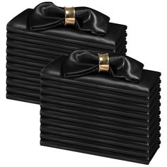 black leather napkins with gold bows on them