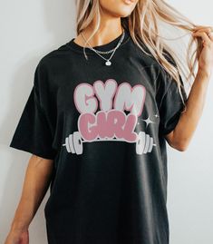 A T-shirt designed for the gym girl or weightlifting enthusiast, also perfect for the muscle mommy. This garment gives off a sporty and strong vibe, ideal for workouts or casual wear. It is relevant for fitness holidays like National Fitness Day. Product features - Available in multiple sizes from S to 4XL - Double-needle stitching for durability - Knit in one piece without side seams - Garment-dyed fabric for soft texture - Made with high quality 100% ring-spun US cotton Care instructions - Mac Muscle Mommy Workout, Muscle Mommy, Mommy Workout, Gym Girl, Fitness Apparel, Dye Shirt, Gym Shirts, Workout Tshirts, Dyed Fabric