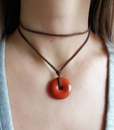 Red jasper pendant necklace; gift for woman; layered tan suede necklace -genuine red jasper gemstone pendant;  -stainless steel (non tarnish) claps closure -faux suede leather cord -ready to give as a gift, this necklace comes wrapped in a nice jewelry pouch. Please measure the neck circumference before order then select the correct size. Size is related to the upper layer of the necklace (the short layer)  Please notice that the pictures are suggestive and the original necklace may vary slightl Adjustable Spiritual Round Pendant Jewelry, Brown Jewelry With Natural Stones As Gift, Adjustable Choker Jewelry Gift, Brown Natural Stone Jewelry For Gifts, Brown Natural Stone Jewelry As A Gift, Brown Natural Stone Jewelry Gift, Adjustable Length Choker As A Gift, Minimalist Amber Round Pendant Jewelry, Adjustable Gemstone Choker