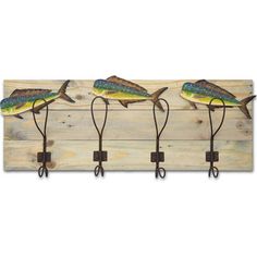 three fish hooks mounted to a wooden wall