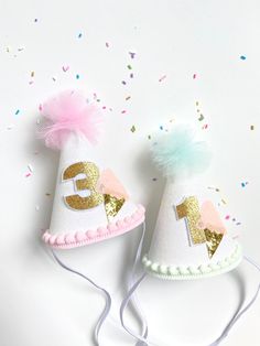 "This pink or mint ice cream cone MINI birthday party hat is the perfect accessory for your little one's big day, cake smash or photo session. All hats are made to order. Each hat along with the bows and embellishments are carefully handcrafted so each hat is unique and will vary slightly because of this.  PLEASE LEAVE A NOTE AT CHECKOUT WITH YOUR EVENT DATE. MINI PARTY HAT FEATURES: -White glitter card stock MINI party hat designed with a custom template -Approximately 5'' tall x 3'' wide  -Pin Glitter Ice Cream, Tulle Poms, Glitter Number, Mini Pinscher, Mint Ice Cream, Birthday Party Hats, Mini Party, Elastic Headband, Pom Pom Trim