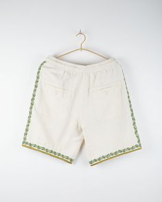 Our hand embroidered design was inspired by the beauty of traditional wall art and uses a special art form called Chikankari. Our Chikankar artisans live in Lucknow, where this technique is a specialty of that region. It takes a Chikankar a decade to learn and train. Featured on our Dipak shorts which have a regular rise, drawstring elastic waist. Relaxed fitting and utilitarian in nature, they are complete with special elements including a handmade drawcord, reinforced back pocket detail and fi Chikankari Embroidery, Traditional Wall Art, Embroidered Design, Pocket Detail, Hand Embroidered, Elastic Waist, Take That, Relaxed Fit, Train