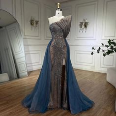 a dress is displayed on a mannequin in a room with white walls and wooden floors