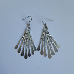 These earrings are handmade in hammered metal. They are 52 mm (2 inches) from the top of the ring to the bottom of the longest wire, and are light and comfortable to wear.  Wear with the matching fringe statement necklace for maximum effect. Handmade Metal Long Drop Chandelier Earrings, Long Drop Metal Chandelier Earrings With Ear Wire, Adjustable Metal Dangle Chandelier Earrings, Long Drop Metal Chandelier Earrings, Adjustable Metal Chandelier Earrings With Ear Wire, Silver Long Drop Chandelier Earrings In Brass, Silver Metal Long Drop Chandelier Earrings, Silver Hammered Dangle Chandelier Earrings, Teardrop Metal Chandelier Earrings