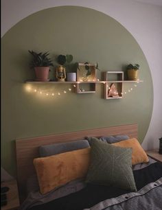 a bed with some plants and lights on the headboard