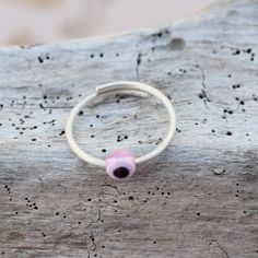 Pink eye, evil eye ring, open sterling silver ring 1.3 mm thick. Stackable ring. All our products are handmade in our little workshop with much care and love. You are welcome to send us a message if you have any questions! Best, Christina OPTION TO UPGRADE AT CHECKOUT WITH DHL Express FOR DELIVERY IN 3-5 DAYS Pink Stackable Midi Rings As Gift, Pink Adjustable Sterling Silver Stackable Rings, Adjustable Pink Sterling Silver Stackable Rings, Handmade Pink Toe Ring Jewelry, Minimalist Adjustable Pink Stackable Rings, Pink Adjustable Toe Ring, Adjustable Pink Toe Ring, Handmade Pink Toe Ring, Adjustable Pink Midi Rings