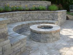 an outdoor fire pit surrounded by stone walls