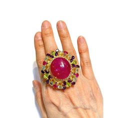 Cluster Multi Color Fancy Gems from Sri Lanka Ruby - 12 Carat Amethyst - 3 Carat Peridot - 2 Carat Blue Topaz - 2 Carat Citrine 3 Carat White Topaz - 1 Carat  This Ring is from the "Orient" traveling collection are the epitome of elegance and versatility. It offers a perfect blend of day to night and swimwear to evening wear, allowing you to effortlessly transition between different occasions and outfits. Wearing these spectacular oriental-style ring will undoubtedly make you the center of attention. It addw a touch of glamour and sophistication to your favorite caftans, swimwear, or evening attire, enhancing your overall look. The "Orient" collection, from which this ring originates, showcases exceptional craftsmanship and incorporates natural gemstones. The ring is set in 18k gold and si Elegant Multicolor Cabochon Gemstones, Elegant Multicolor Cabochon Rings, Luxury Multi-stone Pink Gemstones, Luxury Pink Multi-stone Gemstones, Luxury Multi-stone Amethyst Wedding Ring, Multicolor Cabochon Rings For Formal Occasions, Luxury Multicolor Oval Gemstones, Formal Multicolor Cabochon Rings, Multicolor Luxury Amethyst Ring For Formal Occasions