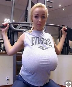 a pregnant woman sitting on top of a gym machine