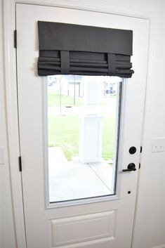 a white door with a black blind on it