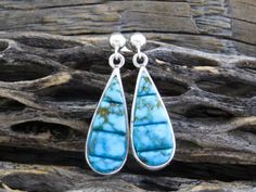 Turquoise Earrings, Native American Navajo Kingman Turquoise Sterling Silver Post Teardrop Earrings Signed Shop Here: https://etsy.me/2XeXQRh These beautiful, post, dangle, teardrop shaped earrings with the turquoise stones slightly raised are simply stunning.  The intense blue color with brown matrix is perfect for wearing with casual or dressy outfits.  There is a simple elegance about these earrings.  They are light weight and make a very memorable gift that will last a lifetime. Post Drop Ea Earrings Native American, Turquoise Stones, Kingman Turquoise, Dressy Outfits, Fringe Earrings, Photo Bracelet, Simple Elegance, Turquoise Earrings, Memorable Gifts