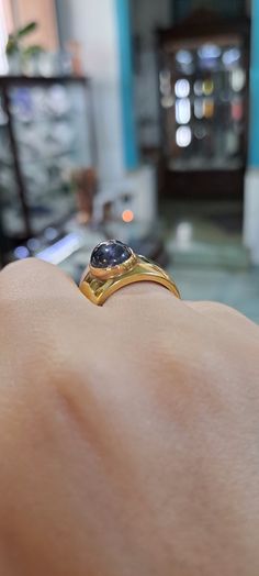 This Ring in 18k Gold with an Iolite makes a beautiful addition to any jewelry collection. The warm color of the 18k gold holds the mesmerizing Iolite for a stunning contrast. A true show stopper, this beautiful and unique ring is sure to turn heads. Luxury Tanzanite Yellow Gold Ring, Yellow Gold Tanzanite Rings, Yellow Gold Tanzanite Ring With Polished Finish, Luxury Yellow Gold Tanzanite Ring, Timeless Hallmarked Sapphire Ring, Gold Tanzanite Gemstone Rings, Luxury Yellow Sapphire Round Ring, Modern Yellow Gold Sapphire Ring With Center Stone, Gold Tanzanite Round Rings