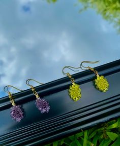 Delight in the whimsy of our Purple and Green Grape Dangle Earrings. These exquisite earrings feature intricately designed grape clusters in a captivating combination of purple and green hues. Handcrafted with meticulous attention to detail, our Grape Dangle Earrings showcase the beauty of nature's bounty. Made from high-quality materials, they offer both durability and style. Whether you're a fruit lover or seeking a unique accessory, these earrings are perfect for adding a touch of playfulness to your look. Shop now and indulge in the allure of these fruity delights! Hand Evil Eye, Green Grape, Grape Color, Fruit Jewelry, Nature's Bounty, Green Grapes, Green Hues, Heart Dangle Earrings, A Fruit