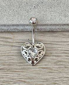 This ornate silver heart features crystals in a gorgeous elegant design, that's minimalistic enough for everyday wear. Drop jaws with this body jewelry. Also available in gold! Details & Size: ♥ 316L Surgical Steel ♥ 10mm bar, 14G ♥ Every purchase comes with an Elara gift box Please message me if you have any questions We hope you love our jewelry as much as we do! Elegant Heart-shaped Wedding Belly Rings, Nickel Free Elegant Heart Ring, Elegant Heart-shaped Belly Rings, Elegant Nickel-free Heart Ring, Elegant Heart-shaped Internally Threaded Belly Rings, Silver Belly Rings For Valentine's Day, Valentine's Day Gift Silver Belly Rings, Silver Heart Belly Rings For Valentine's Day, Valentine's Day Silver Heart Belly Rings