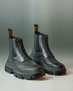 A new era begins. The 2976 Chelsea boot reworked and reimagined. An experiment that questions the nature of our traditional silhouettes and recontextualises our industrial design history through a modernist lens. Retaining the classic slip-on elasticated gussets with the addition of a front facing water-resistant AquaGuard zip enclosure. The Chelsea boot form has been distorted with contrasting material panels to create textural contradictions. The construction prioritises soft, full-grain Lunar 2976 Chelsea Boots, Dr Martens Chelsea, Dr Martens 2976, Platform Shoes Sandals, Lightweight Boots, Platform Chelsea Boots, Patent Boots, Botas Chelsea, Casual Footwear