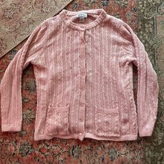 "Vintage pink cardigan. Long sleeves, open lightweight weave, with matching plastic buttons up the front.  Good condition.  Brand: Anthony Richards Size: Adult Large Material: Acrylic  Measurements: 29\" long 24\" pit to pit" Casual Open Knit Cardigan For Daywear, Classic Pink Button-up Sweater, Spring Cable Knit Button-up Cardigan, Pink Casual Cable Knit Cardigan, Casual Pink Cable Knit Cardigan, Pink Cable Knit Casual Cardigan, Pink Open Knit Outerwear For Layering, Pink Button-up Cotton Cardigan, Pink Cotton Button-up Cardigan