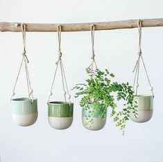 four hanging planters with plants in them