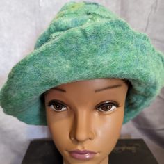 This One Of A Kind Hat Is Light Green With Accents Of Darker Green And Yellow. It Can Be Worn As A Beanie, Or The Brim Can Be Flipped Up. The Wool Felt Is Thick And Warm, Perfect For Winter. It Was Made By Hand Using A Wet Felting Process Which Takes Wool Roving, Accents Of Silk, Hot Water, Natural Soap, And A Lot Of Massaging Until It Is A Fabric. It Is Brand New Without Tags. Wool Roving, Cloche Hat, Wet Felting, Green Wool, Felt Hat, Green And Yellow, Fantasy Fashion, Natural Soap, Wool Hat