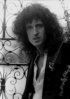 a black and white photo of a man with curly hair