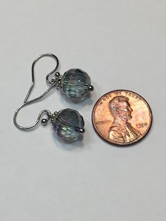 "Blue Aurora Borealis 10mm faceted disco ball glass beads, stainless steel hook wire dangling earrings. 1\" top to bottom, dangle 1/2 inches. Hand made Jewelry! Thanks for stopping by!" Iridescent Round Jewelry With Ear Wire, Nickel-free Crystal Earrings For Party, Nickel-free Round Crystal Earrings For Party, Adjustable Iridescent Drop Earrings, Metal Earrings With Faceted Beads, Iridescent Wire Wrapped Drop Earrings, Czech Glass Crystal Dangle Earrings, Nickel-free Iridescent Round Earrings, Party Earrings With Czech Glass