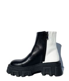 These fabulous ankle boots are crafted in a black and white leatherette and features two detailed 3D circles. Complete with a side zipper, 2 inch heel and 1 1/4 inch platform.Available while supplies last.Runs 1/2 size big; sizing down recommended.Please note these shoes have a 2-3 day handling time before they will ship from our warehouse and there is a 10% restocking fee if you choose to return.