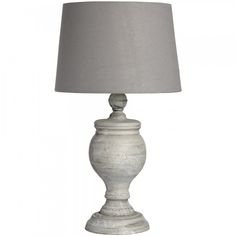 a white table lamp with a gray shade on it's base and a light grey linen shade on the top