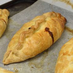 baked pastries sitting on top of a baking sheet