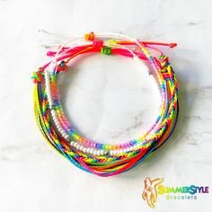 multicolored bracelets on white marble background