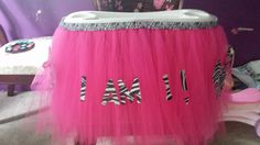 a pink tulle skirt with zebra print on the bottom and letters that spell love