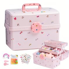 a pink suitcase with stuffed animals in it and other items surrounding it on a white background