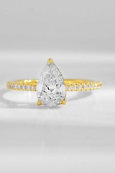 Stand out with this elegant pear cut diamond engagement ring. From its stunning centre stone to its delicate diamond band, this Ecksand Custom jewel was designed to sparkle.

#engagementring #engagementrings #ring #rings #diamondrings #diamondringsforwomen #jewelry #goldjewelry #goldring #goldrings #pearengagementring #pearcutengagementring #beauxbijoux Pear Cut Diamond Engagement Ring, Dream Engagement Rings, Custom Ring